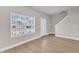 Spacious living room with large window, luxury vinyl plank flooring, and neutral paint at 107 Wilderness Ct, Mebane, NC 27302