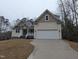 Charming home with a two-car garage, manicured lawn, and inviting curb appeal in a serene setting at 143 Oswego Dr, Louisburg, NC 27549