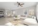 Bright living room with L-shaped sofa, coffee table, and large windows at 124 W College St, Oxford, NC 27565