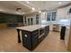 A kitchen island featuring a microwave and marble countertop with a view of the dining and fireplace at 129 Mayan Dr, Louisburg, NC 27549