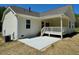 View of backyard with patio and covered porch with steps from house at 19 Covey Rise Way, Lillington, NC 27546
