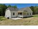 View of the backyard showing the covered porch, patio, and side of the house at 19 Covey Rise Way, Lillington, NC 27546