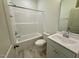 Bright bathroom featuring tile floors, a bathtub, and a sink with a vanity at 19 Covey Rise Way, Lillington, NC 27546