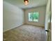 Bright bedroom with a neutral carpet and a window overlooking the greenery at 19 Covey Rise Way, Lillington, NC 27546