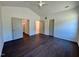 Spacious bedroom featuring vaulted ceiling, wood floor, a ceiling fan and multiple doorways at 19 Covey Rise Way, Lillington, NC 27546
