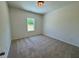 Neutral carpeted bedroom with natural light from the window at 19 Covey Rise Way, Lillington, NC 27546