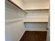 Walk-in closet with multiple shelves providing ample storage space, and hardwood floors at 19 Covey Rise Way, Lillington, NC 27546