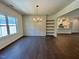 Open dining room with wainscoting, built-in shelving, and hardwood floors at 19 Covey Rise Way, Lillington, NC 27546