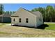Home exterior with covered porch and patio overlooking green lawn at 19 Covey Rise Way, Lillington, NC 27546