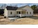 Rear view of house showcasing covered porch and patio at 19 Covey Rise Way, Lillington, NC 27546