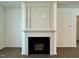 Elegant fireplace with white mantle and dark firebox, prewired for media, complements the hardwood floors at 19 Covey Rise Way, Lillington, NC 27546