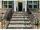 Exterior front entrance with stone steps and black door at 19 Covey Rise Way, Lillington, NC 27546