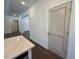 Hallway with wood look floors leads to rooms with a louvered door, accented by fresh white paint at 19 Covey Rise Way, Lillington, NC 27546