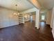 Spacious living room featuring hardwood floors and a view into the modern kitchen at 19 Covey Rise Way, Lillington, NC 27546