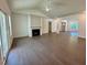 Open-concept living room with a fireplace and access to the outdoor space at 19 Covey Rise Way, Lillington, NC 27546