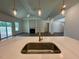 Bright open-concept living area with modern fixtures, hardwood floors, and a view to outdoor living area at 19 Covey Rise Way, Lillington, NC 27546