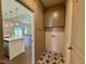 Mudroom featuring star-patterned tile floors, overhead cabinet storage, and access to the sunny living area at 19 Covey Rise Way, Lillington, NC 27546