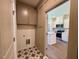 Mudroom featuring star-patterned tile floors, overhead cabinet storage, and access to the bright kitchen at 19 Covey Rise Way, Lillington, NC 27546