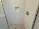 Shower showcasing white subway tile walls with a recessed niche and pebble tile floor at 19 Covey Rise Way, Lillington, NC 27546