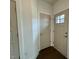 Hallway showcasing neutral-toned doors and hardwood floors, with ample lighting at 222 Grand Griffon Way, Lillington, NC 27546