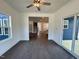 Bright living room featuring hardwood floors, a ceiling fan, and views to the front yard at 222 Grand Griffon Way, Lillington, NC 27546