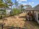 Large backyard bordered by black iron fence and rear home exterior with patio at 316 Spruce Pine Trl, Knightdale, NC 27545