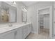 Bathroom with double sinks, tile floors, and a walk-in closet at 316 Spruce Pine Trl, Knightdale, NC 27545