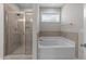 Bright bathroom featuring a glass-enclosed shower and a separate soaking tub at 316 Spruce Pine Trl, Knightdale, NC 27545