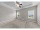 Spacious bedroom featuring neutral carpet, a ceiling fan, and natural light at 316 Spruce Pine Trl, Knightdale, NC 27545