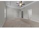 Bedroom with a ceiling fan, plush carpet, and access to an ensuite bathroom at 316 Spruce Pine Trl, Knightdale, NC 27545