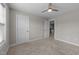 Cozy bedroom with neutral walls, carpet, white doors, and a view to an adjoining room at 316 Spruce Pine Trl, Knightdale, NC 27545