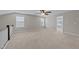 A bonus room featuring carpet, neutral walls, windows, and a ceiling fan with lots of natural light at 316 Spruce Pine Trl, Knightdale, NC 27545