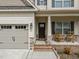 Charming home with a welcoming front porch, featuring rocking chairs and a well-manicured yard at 316 Spruce Pine Trl, Knightdale, NC 27545