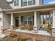 Inviting front porch featuring classic rocking chairs and swing seating, perfect for relaxing, with beautiful brick accents at 316 Spruce Pine Trl, Knightdale, NC 27545