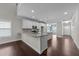 Bright open kitchen with white cabinets, granite counters and stainless steel appliances at 316 Spruce Pine Trl, Knightdale, NC 27545