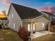 Rear exterior showing covered brick porch with ceiling fan and access to the backyard at 316 Spruce Pine Trl, Knightdale, NC 27545