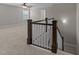 Staircase featuring dark wood banister with white spindles, leading to the upper level with natural light at 316 Spruce Pine Trl, Knightdale, NC 27545