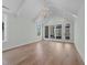 Bright bedroom with hardwood floors, large windows, and a vaulted ceiling with chandelier at 339 1/2 Mulberry St, Raleigh, NC 27604