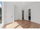 Minimalist bedroom featuring hardwood floors, white walls, and two entryways at 339 1/2 Mulberry St, Raleigh, NC 27604