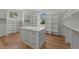 Custom closet featuring hardwood flooring, shelves, and a center island with storage at 339 1/2 Mulberry St, Raleigh, NC 27604