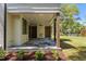 Enjoy this covered patio with stained wood columns, tile flooring, wood ceiling, and outdoor grill at 339 1/2 Mulberry St, Raleigh, NC 27604