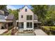 Modern two-story home featuring a light beige upper level and a white first floor with beautiful landscaping at 339 1/2 Mulberry St, Raleigh, NC 27604
