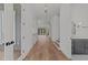 Hallway showcasing hardwood floors, white walls, and staircase leading up to the next floor at 339 1/2 Mulberry St, Raleigh, NC 27604