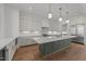 Modern kitchen with a gray island, stainless steel appliances, and stylish pendant lighting at 339 1/2 Mulberry St, Raleigh, NC 27604