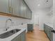 Laundry room with hardwood floors and green cabinetry with gold hardware at 339 1/2 Mulberry St, Raleigh, NC 27604