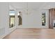 Bright living room featuring hardwood floors, large windows and a modern light fixture at 339 1/2 Mulberry St, Raleigh, NC 27604