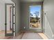 Bright room with hardwood flooring, a neutral wall color, and a view of mature trees at 339 1/2 Mulberry St, Raleigh, NC 27604