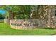 Stone sign with raised lettering for Brookside Village, nestled in lush greenery creates a welcoming entrance at 339 1/2 Mulberry St, Raleigh, NC 27604