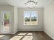 Sunlit dining room with a large window, wood flooring and glass paneled door to outdoor deck at 40 Misty Mountain, Spring Hope, NC 27882