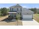 Beautiful two-story home boasting a two-car garage, covered front porch, and a neatly landscaped front yard at 40 Misty Mountain, Spring Hope, NC 27882